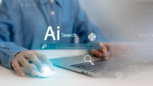 A person using a laptop with AI search interface graphics, related to local SEO and AI search visibility.