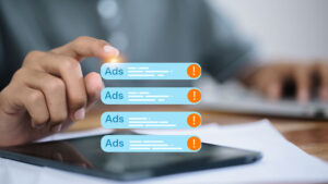 Close up hand touching digital advertising alert notification on mobile phone screen, concept of online marketing, pop up ads, spam warning, digital business technology.