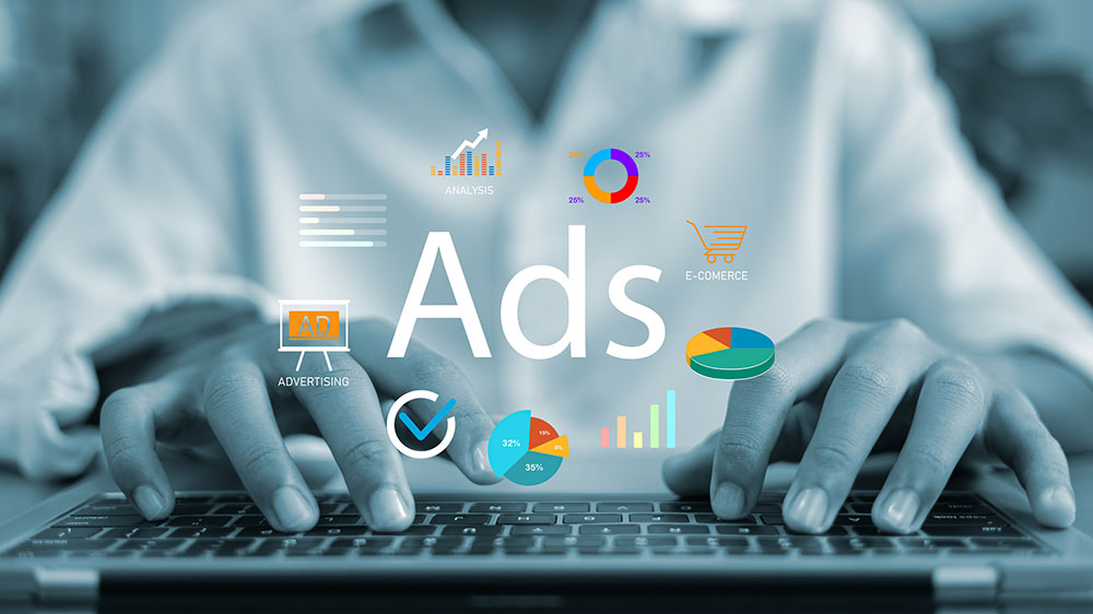 Businessman typing on laptop with digital ads interface, data charts, and marketing icons. Concept of online advertising strategy, e-commerce analysis, and business growth tracking.