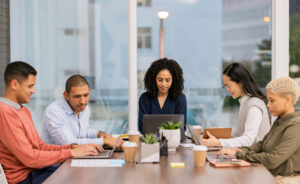 Content marketing SEO, laptop or business people in meeting planning a group or startup project. Team, black woman or employees in collaboration for our vision, sales strategy or ecommerce goals