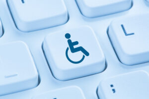 Wheelchair accessibility symbol on computer keyboard key, representing website accessibility and SEO considerations.